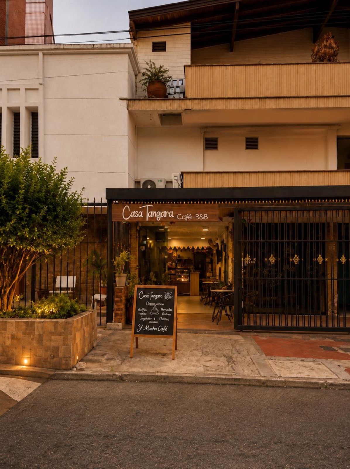 Casa Tángara café facade at dusk on a quiet Laureles street