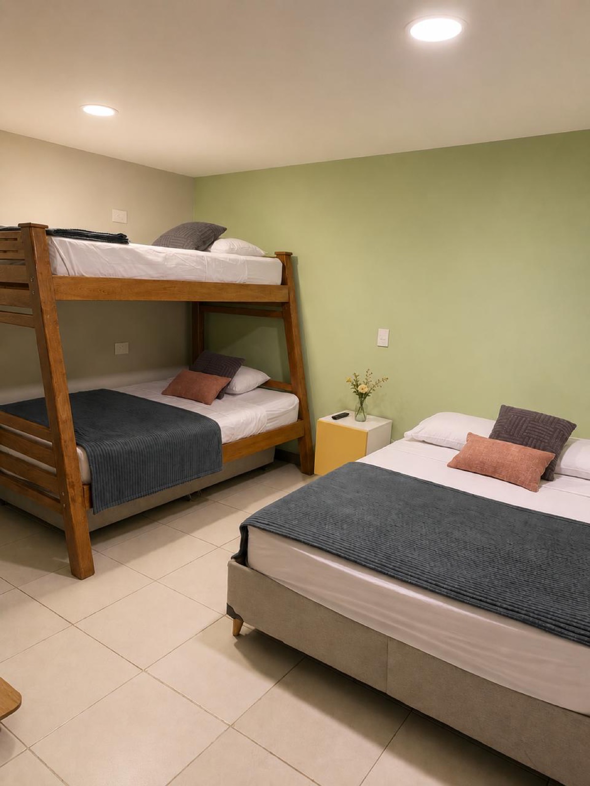 Family room with bunk bed and double bed, green accent wall