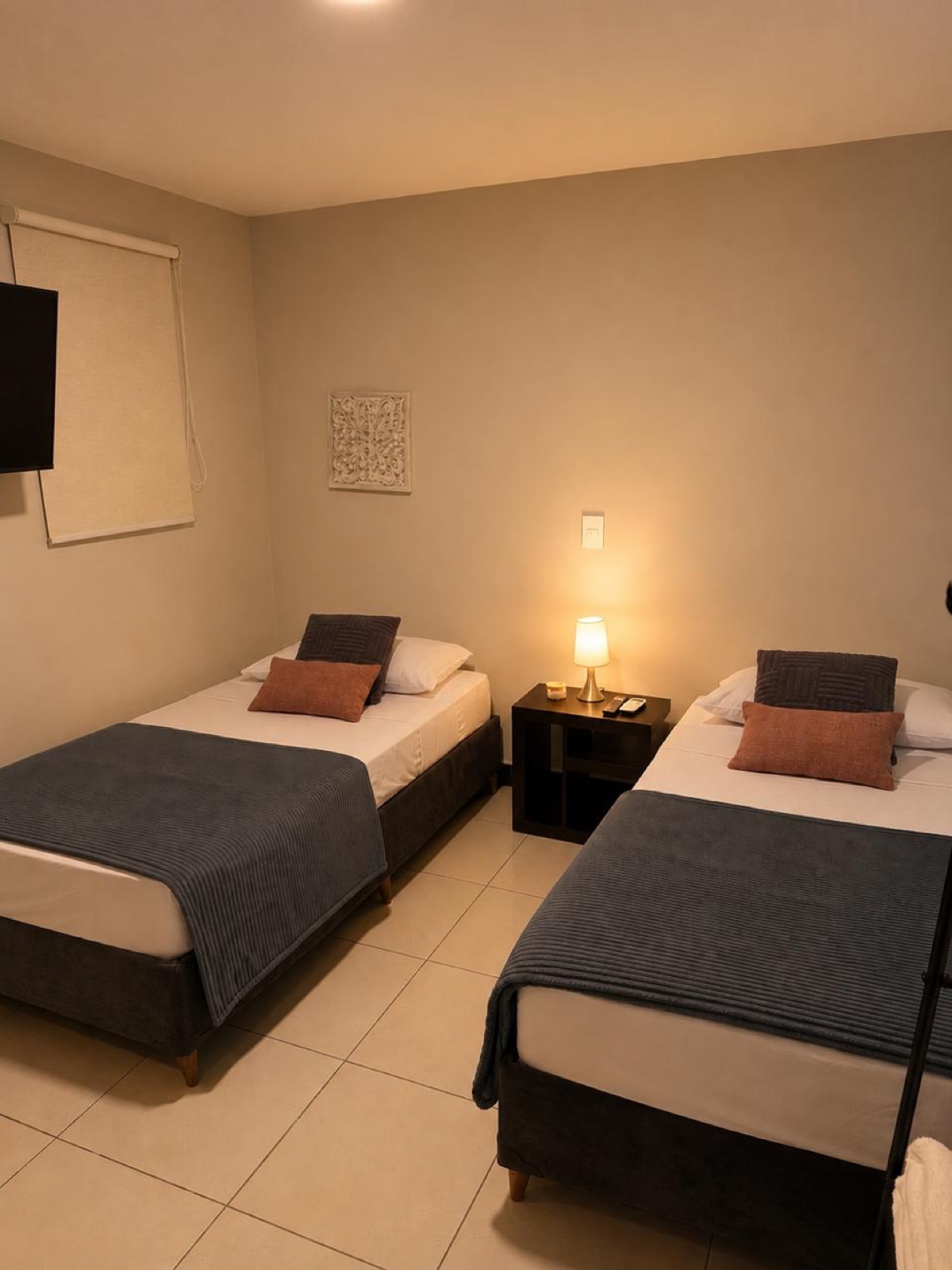Twin room with two single beds and warm lighting